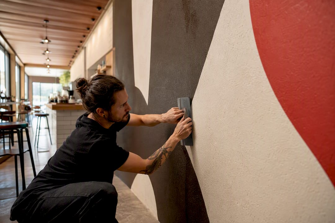 Installer applying branded wall mural