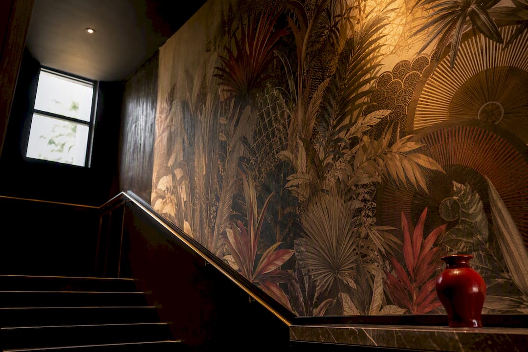 Maximalist wallpaper in a dramatic hotel interior